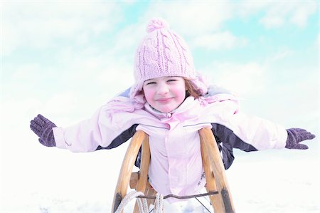 Girl with Outstretched Arms on Sled Stock Photo - Rights-Managed, Code: 700-03814445