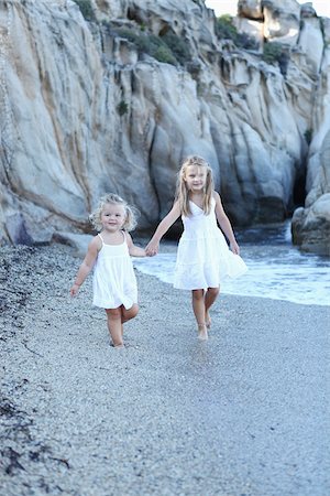 simsearch:700-03739271,k - Sisters Holding Hands on Beach Stock Photo - Rights-Managed, Code: 700-03814463