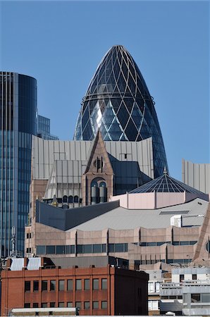 swiss re tower - Swiss Re Tower Peeking Out from Behind Buildings, London, England Stock Photo - Rights-Managed, Code: 700-03836378