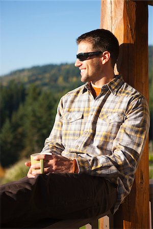 Man Enjoying Cup of Coffee on Porch Stock Photo - Rights-Managed, Code: 700-03849152