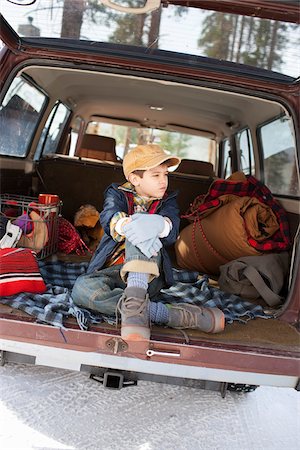 Boy Sitting on Tailgate of Vehicle Stock Photo - Rights-Managed, Code: 700-03849320