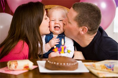 first birthday baby - Parents Kissing Girl at First Birthday Party Stock Photo - Rights-Managed, Code: 700-03908025