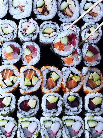 Entire frame sushi overhead with chopsticks lifting a sushi Stock Photo - Rights-Managed, Code: 824-07585975