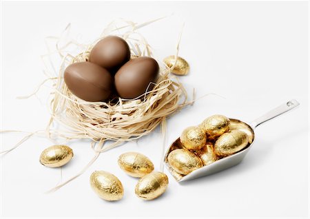 simsearch:825-06047612,k - Three milk chocolate eggs in a nest and small golden eggs Stock Photo - Rights-Managed, Code: 825-05815818