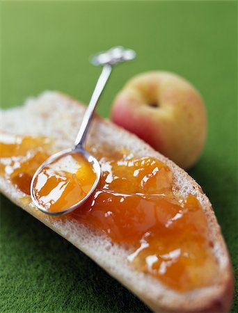 Apricot jam on a slice of bread Stock Photo - Rights-Managed, Code: 825-05811902