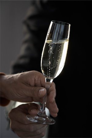 Hands holding a glass of Champagne Stock Photo - Rights-Managed, Code: 825-05836441