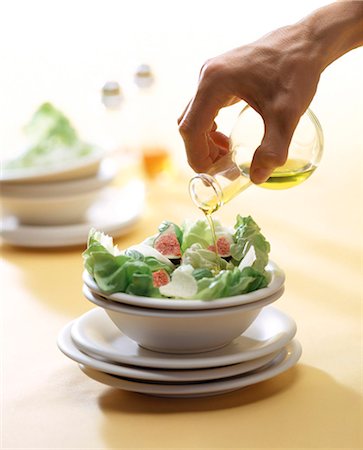 Hand pouring oil over salad Stock Photo - Rights-Managed, Code: 825-05988471