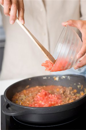 Adding the tomatoes to the preparation Stock Photo - Rights-Managed, Code: 825-06049430