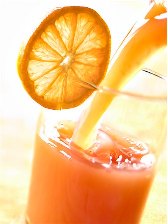 drink flowing - Pouring a mixed pink grapefruit and orange juice Stock Photo - Rights-Managed, Code: 825-06315118