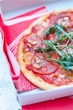 simsearch:825-07522085,k - Tomato,pine nut and rocket pizza Stock Photo - Rights-Managed, Code: 825-06316144