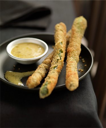 Fried asparagus coated in breadcrumbs with mustard sauce Foto de stock - Con derechos protegidos, Código: 825-06316240