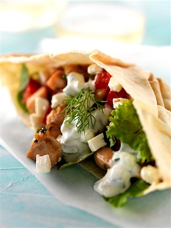 simsearch:825-07522085,k - Chicken,tomato,feta and lettuce pitta bread sandwich with white yoghurt sauce Stock Photo - Rights-Managed, Code: 825-06816128