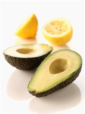 simsearch:825-05812193,k - Cutting in half an avocado and coating with lemon juce Stock Photo - Rights-Managed, Code: 825-06816335