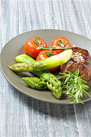 simsearch:825-07522119,k - Thick piece of grilled beef with green asparagus and roast tomatoes Stock Photo - Rights-Managed, Code: 825-07076510