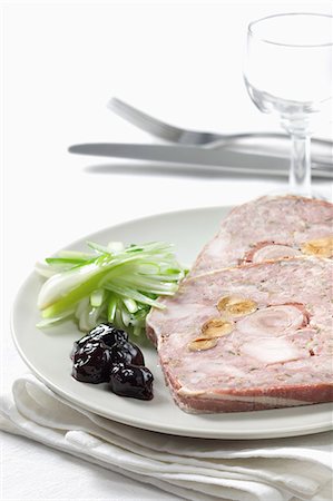 simsearch:652-03804848,k - Slices of rabbit and hazelnut terrine with preserved black cherries and baby leeks Stock Photo - Rights-Managed, Code: 825-07076911