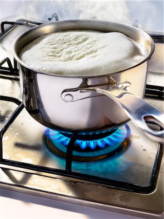 Cooking in a saucepan on a gas cooker Stock Photo - Rights-Managed, Code: 825-03628812