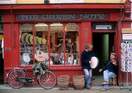person in a basket of a bike - Two men playing a drum and a guitar in front of a store, County Down, Republic Of Ireland Stock Photo - Rights-Managed, Code: 832-02252442