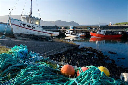 Purteen Harbour, Achill Island, Co Mayo, Ireland; Fishing boats with nets and buoys in foreground Foto de stock - Con derechos protegidos, Código: 832-03359290