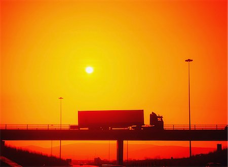 semi - Dublin,Ireland;Truck Driving Over Bridge Silhouetted By Sunset Stock Photo - Rights-Managed, Code: 832-03639695