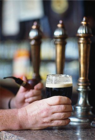 pubs ireland pictures - Hand Holding Glass Of Guinness In Irish Pub, Ireland Stock Photo - Rights-Managed, Code: 832-03640655