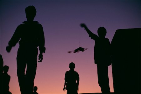 flying kite outdoor - Silhouettes of people flying kites Stock Photo - Rights-Managed, Code: 832-03724312