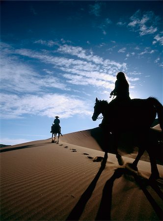 Horseback riders in silhouette on sand dune Stock Photo - Rights-Managed, Code: 832-03724382