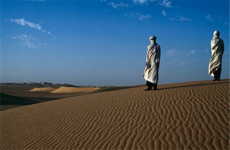 Men standing on sand dunes Stock Photo - Rights-Managed, Code: 832-03724403