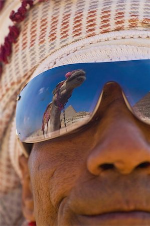 Camel and pyramids reflecting in local man's sunglasses Stock Photo - Rights-Managed, Code: 832-03724788