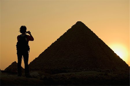 simsearch:400-07096057,k - Silhouette of woman photographing Pyramids at dusk Stock Photo - Rights-Managed, Code: 832-03724919