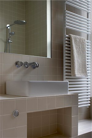 radiator (heater) - heated radiator and washbasin with mirror, Greencroft Gardens Apartment, London, UK. Architects: Openstudio Stock Photo - Rights-Managed, Code: 845-05837711