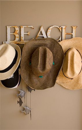 Straw hats on hook with 'BEACH' lettering. Stock Photo - Rights-Managed, Code: 845-05837789