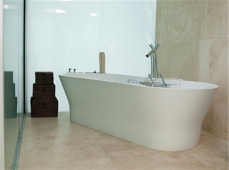 simsearch:845-07561516,k - Freestanding modern white bath with cream marble floor and wall. Architects: Terry Farrell and Partners Stock Photo - Rights-Managed, Code: 845-05837926