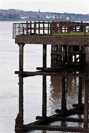 simsearch:845-05838406,k - Old concrete pier structure in the docks by the side of the River Mersey, Liverpool, with New Brighton in the background. Stock Photo - Rights-Managed, Code: 845-05838364