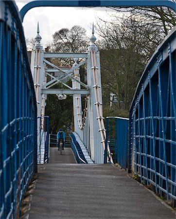 simsearch:845-05838406,k - A man riding a bike on the suspension bridge over the River Thames at Teddington Lock. Stock Photo - Rights-Managed, Code: 845-05838368