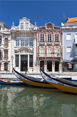 portugal - Art Nouveau buildings and the prows of traditional moliceiros boats moored on the canal at Aveiro, Portugal Stock Photo - Rights-Managed, Code: 845-07584912