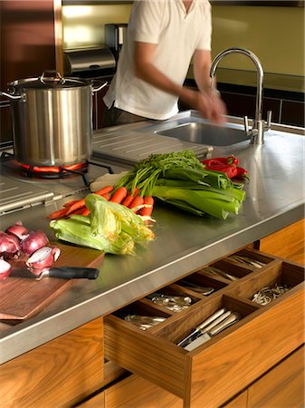 european union - House in Chelsea, London. Modern stainless steel, dark wooden island unit with open drawer and fresh vegetables and onions on chopping board. Architects: Chris Dyson Architects Stock Photo - Rights-Managed, Code: 845-03720700