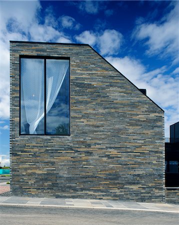 eco house - Scotland's Housing Expo. The Stone House. looking at the end wall and large window in the double height end of the terrace. Architects: NORD Stock Photo - Rights-Managed, Code: 845-03721264