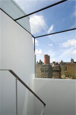 simsearch:845-06008034,k - Handrail with view out towards chimneys from a Victorian house, Wandsworth, London. Architects: Luis Treviño Fernandez Stock Photo - Rights-Managed, Code: 845-03777307