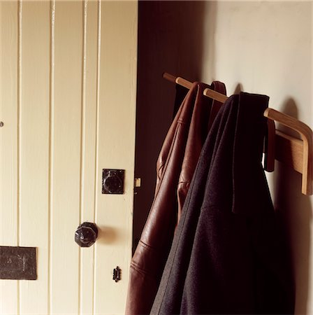 peg - Coats hanging on a coat peg by a wooden painted front door. Stock Photo - Rights-Managed, Code: 845-03777467