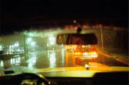 simsearch:846-02795606,k - 1980s MAN REFLECTED IN REARVIEW MIRROR DRIVING CAR RAINY CHICAGO STREET AT NIGHT Stock Photo - Rights-Managed, Code: 846-05645694