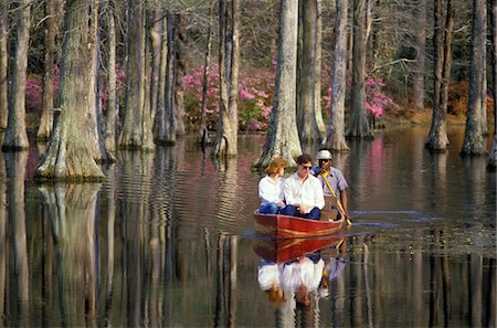 1980s TOURIST COUPLE IN WOOD GUIDE BOAT CYPRESS GARDENS CHARLESTON SOUTH CAROLINA USA Stock Photo - Rights-Managed, Code: 846-05645699