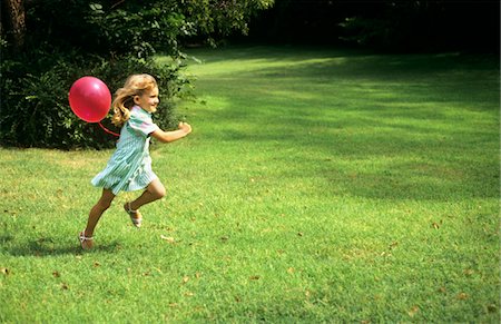 1980s LITTLE GIRL WITH A RED BALLOON RUNNING IN THE GRASS Stock Photo - Rights-Managed, Code: 846-05645727