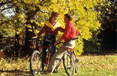 1980s - 1990s YOUNG COUPLE OUTDOORS IN AUTUMN SITTING ON BICYCLES Stock Photo - Rights-Managed, Code: 846-05645728