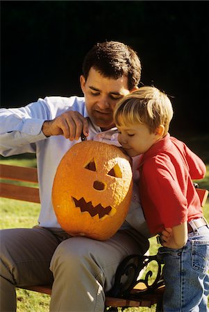 1990s FATHER AND SON CARVING A HALLOWEEN PUMPKIN OUTDOORS Stock Photo - Rights-Managed, Code: 846-05645807