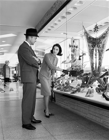 1950s COUPLE MAN WOMAN WINDOW SHOPPING WOMAN POINTING TO PAIR OF SHOES IN STORE WINDOW DISPLAY Stock Photo - Rights-Managed, Code: 846-05645913