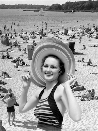 1930s VACATION MONTAGE PORTRAIT SMILING WOMAN IN BATHING SUIT WEARING LARGE STRAW HAT AND SCENE OF CROWDED BEACH Stock Photo - Rights-Managed, Code: 846-05645973