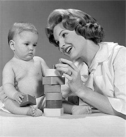 1960s, SMILING MOTHER AND UNHAPPY BABY PLAYING WITH BLOCKS Stock Photo - Rights-Managed, Code: 846-05646004