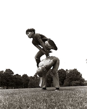 1970s PAIR OF BOYS OUTSIDE IN FIELD PLAYING LEAPFROG Stock Photo - Rights-Managed, Code: 846-05646070