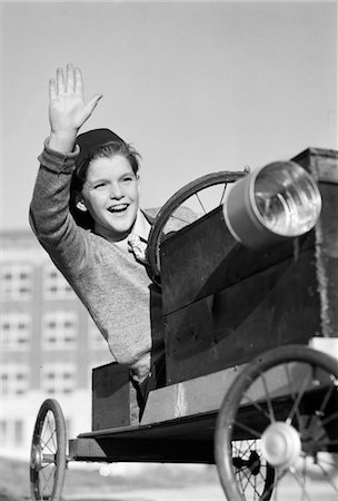 1940s BOY IN HOMEMADE RACE CAR GO-CART SMILING AND WAVING SOAPBOX DERBY Stock Photo - Rights-Managed, Code: 846-05646147