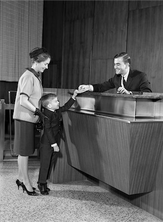 1960s MOTHER IN BANK WITH SON HANDING PASSBOOK TO TELLER Stock Photo - Rights-Managed, Code: 846-05646189